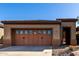 Attached garage with tan paint and a private entrance into the property at 26735 N 127Th Dr, Peoria, AZ 85383