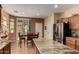 Bright kitchen featuring an island, stainless steel refrigerator, and a dining area at 26735 N 127Th Dr, Peoria, AZ 85383