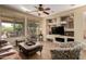 Cozy living room with large windows, built-in shelving, and comfortable seating at 26735 N 127Th Dr, Peoria, AZ 85383