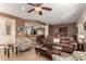 Open-concept living room with bar seating into kitchen and leather sofa at 26735 N 127Th Dr, Peoria, AZ 85383