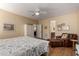 Neutral main bedroom with ceiling fan, closet and view to main bathroom at 26735 N 127Th Dr, Peoria, AZ 85383