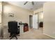 Functional office space with carpet, desk, and closet with mirrored doors at 26735 N 127Th Dr, Peoria, AZ 85383
