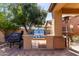 Outdoor kitchen with stainless steel grill, Traeger smoker, and ample counter space for meal preparation at 26735 N 127Th Dr, Peoria, AZ 85383