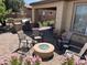 This patio features a cozy seating area with a fire pit, an outdoor kitchen, and a beautiful covered space at 26735 N 127Th Dr, Peoria, AZ 85383