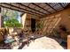 Inviting outdoor patio with pergola, lounge seating, and decorative plants at 26735 N 127Th Dr, Peoria, AZ 85383