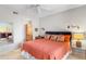 Cozy bedroom featuring a mirror, ceiling fan, a comfortable bed, and a vanity area off to the side at 29606 N Tatum Blvd # 128, Cave Creek, AZ 85331