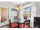 Inviting dining area featuring modern chandelier, large window, and access to outdoor patio at 29606 N Tatum Blvd # 128, Cave Creek, AZ 85331