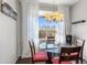 Bright dining area with natural light, featuring a glass-top table, and patio access through a glass door at 29606 N Tatum Blvd # 128, Cave Creek, AZ 85331