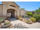 Welcoming entrance with arched doorway, stone accents, and beautiful landscaping with a peaceful water feature at 29606 N Tatum Blvd # 128, Cave Creek, AZ 85331