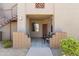 Charming building entrance featuring cozy seating and an inviting outdoor space with wrought iron staircase at 29606 N Tatum Blvd # 128, Cave Creek, AZ 85331