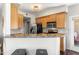 Charming kitchen featuring stainless steel appliances, wood cabinets, and countertop seating at 29606 N Tatum Blvd # 128, Cave Creek, AZ 85331