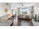 Bright living room featuring wood floors, neutral walls, large windows, ceiling fan and an open floor plan at 29606 N Tatum Blvd # 128, Cave Creek, AZ 85331