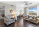 Bright living room featuring wood floors, neutral walls, large windows, ceiling fan and an open floor plan at 29606 N Tatum Blvd # 128, Cave Creek, AZ 85331