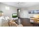Inviting living room with wood floors, ceiling fan, neutral walls, and large windows providing plenty of light at 29606 N Tatum Blvd # 128, Cave Creek, AZ 85331