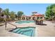 Community pool area complete with a jacuzzi, lounge chairs, tables and umbrellas for shade at 29606 N Tatum Blvd # 128, Cave Creek, AZ 85331