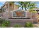 Community sign with stone and brick detailing and red flowers lining the bottom at 29606 N Tatum Blvd # 128, Cave Creek, AZ 85331