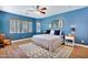 Bedroom with blue walls, ceiling fan, and a view of window and cabinet at 3631 S Salt Cedar St, Chandler, AZ 85286