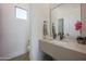 Contemporary bathroom featuring floating vanity, sleek fixtures, and natural light from above at 3015 W Irvine Rd, Phoenix, AZ 85086
