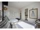 Cozy bedroom featuring twin beds, modern decor, and a hallway to an en-suite bathroom at 3015 W Irvine Rd, Phoenix, AZ 85086