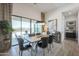 Elegant dining room featuring a stylish table, modern lighting, and outdoor views at 3015 W Irvine Rd, Phoenix, AZ 85086