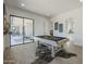 Spacious game room with pool table, stylish flooring, and access to outdoor living at 3015 W Irvine Rd, Phoenix, AZ 85086