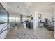 Bright, open-concept living room with tile floors and modern furnishings leading to a dedicated workspace at 3015 W Irvine Rd, Phoenix, AZ 85086
