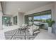 Outdoor covered patio with seating, rug, and sliding glass doors, perfect for enjoying the outdoor scenery at 3015 W Irvine Rd, Phoenix, AZ 85086