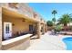 Covered patio overlooks a backyard oasis with pool and desert landscaping at 4152 N Signal Cir, Mesa, AZ 85215