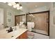 Bathroom featuring a sink, toilet, and shower-tub combo with glass doors at 4152 N Signal Cir, Mesa, AZ 85215