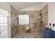 Large walk-in shower with glass block window, bench, and dual shower heads at 4152 N Signal Cir, Mesa, AZ 85215