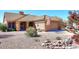 Charming home featuring a tile roof, desert landscaping, and an attached two-car garage at 4152 N Signal Cir, Mesa, AZ 85215
