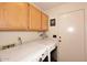 Laundry room with washer, dryer, upper cabinets, and a utility closet at 4152 N Signal Cir, Mesa, AZ 85215