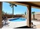 Relaxing view of the backyard pool, patio, and desert landscaping at 4152 N Signal Cir, Mesa, AZ 85215