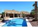 A beautiful pool is surrounded by a covered patio and desert landscaping, perfect for enjoying the outdoors at 4152 N Signal Cir, Mesa, AZ 85215