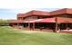 The Players Grill offers outdoor seating with shade and beautiful views of the surrounding green landscape and clubhouse at 4152 N Signal Cir, Mesa, AZ 85215