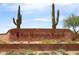 Red Mountain Ranch community entrance sign with desert landscaping and cacti adds charm to the neighborhood's welcome at 4152 N Signal Cir, Mesa, AZ 85215