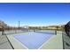 A view of community tennis courts with blue surface surrounded by black fencing at 4152 N Signal Cir, Mesa, AZ 85215