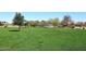 A grassy community volleyball court with a net and surrounding greenery at 4152 N Signal Cir, Mesa, AZ 85215