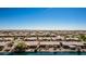 An aerial view showcasing a desert community with lakes, lush landscaping, and well-maintained homes at 41960 W Ellington Ln, Maricopa, AZ 85138