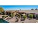 An inviting backyard with desert landscaping, a patio with an umbrella, and comfortable lounge chairs by the water at 41960 W Ellington Ln, Maricopa, AZ 85138