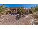 A backyard with decorative landscaping, rock covering, desert foliage and stone accents at 41960 W Ellington Ln, Maricopa, AZ 85138