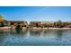 Scenic backyard view showcasing the waterfront property with lush landscaping and charming patio spaces at 41960 W Ellington Ln, Maricopa, AZ 85138