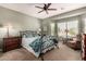 Bedroom with natural light, a ceiling fan, and views of the community at 41960 W Ellington Ln, Maricopa, AZ 85138
