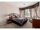 Comfortable bedroom with neutral decor and a bay window at 41960 W Ellington Ln, Maricopa, AZ 85138