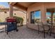 Covered patio featuring a built-in BBQ grill and an outdoor dining area at 41960 W Ellington Ln, Maricopa, AZ 85138