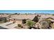 Beautiful desert home boasts a front yard with lush landscaping, a two-car garage, and mountain views at 41960 W Ellington Ln, Maricopa, AZ 85138