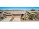 Charming single-story home features a low-maintenance yard, a two-car garage, and mountain views at 41960 W Ellington Ln, Maricopa, AZ 85138