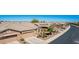 A cozy home features desert landscaping, an attached garage, and a front patio with chairs and a table at 41960 W Ellington Ln, Maricopa, AZ 85138