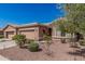 Attractive front exterior with well-maintained landscaping, a three-car garage and inviting curb appeal at 41960 W Ellington Ln, Maricopa, AZ 85138