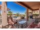 Inviting covered patio featuring comfortable seating and a serene view of a landscaped water feature at 41960 W Ellington Ln, Maricopa, AZ 85138